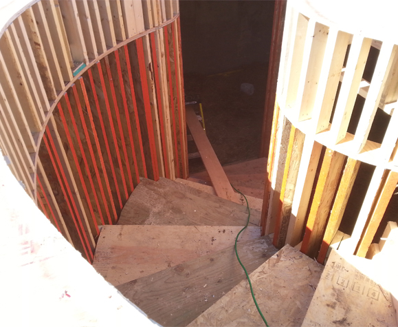 Interior veiw looking down a staircase that is being built